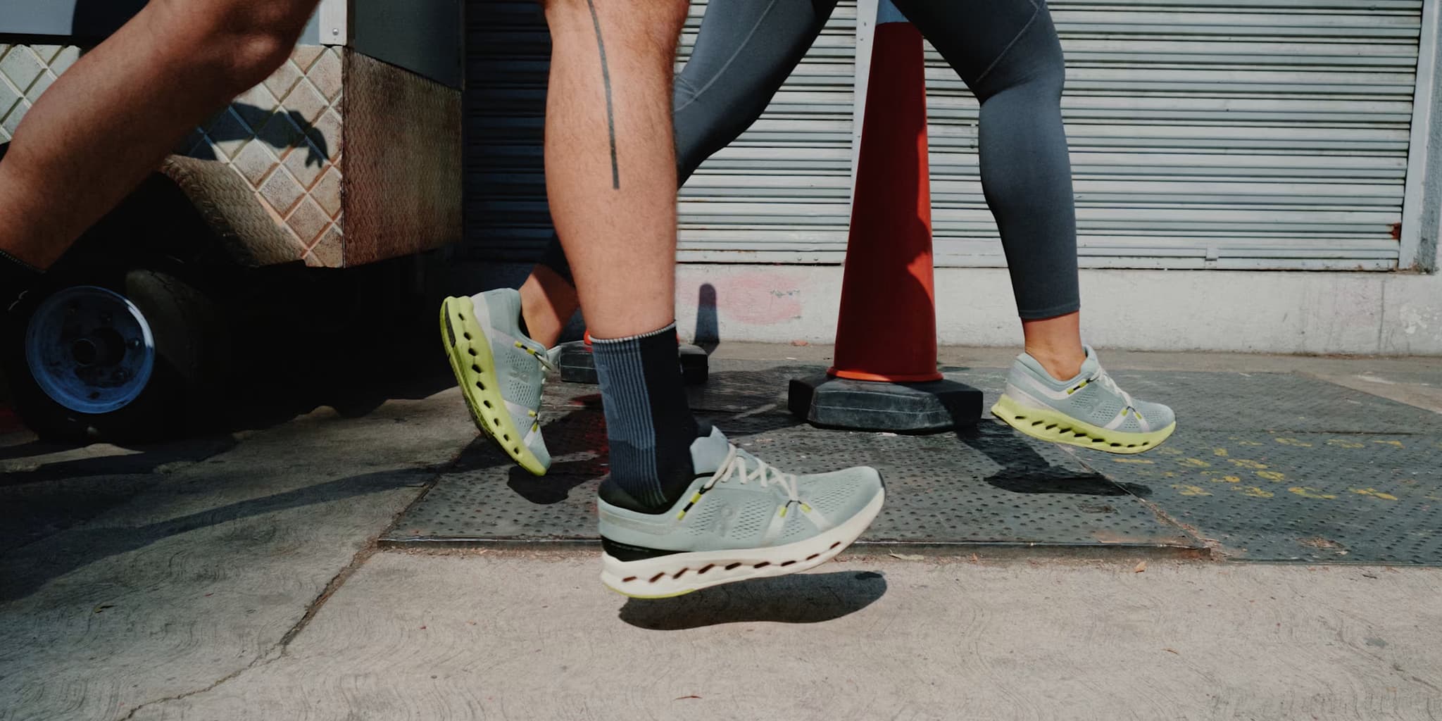 Person wearing light-colored running shoes with a focus on the feet and lower legs.