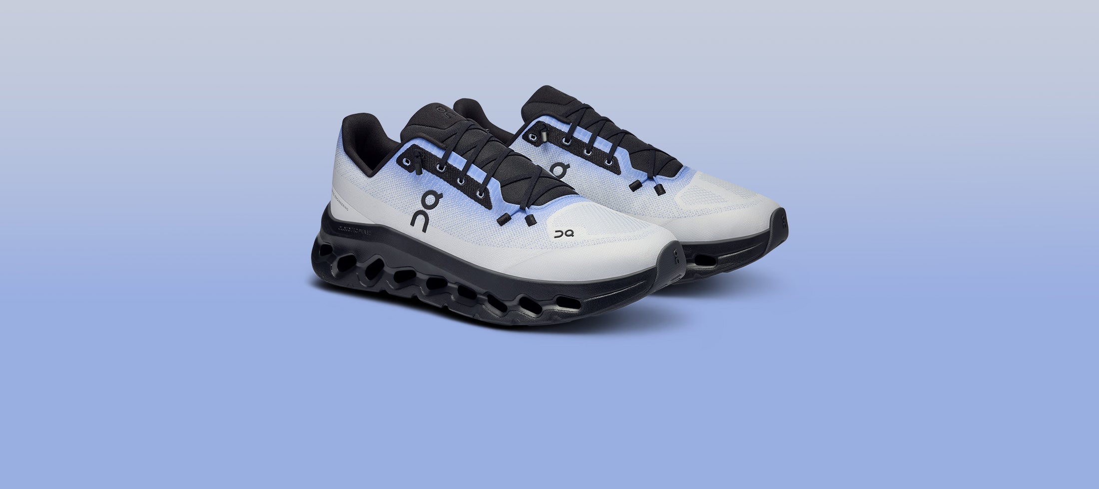 Grey Blue Cloudtilt shoes with black accents on a light blue background