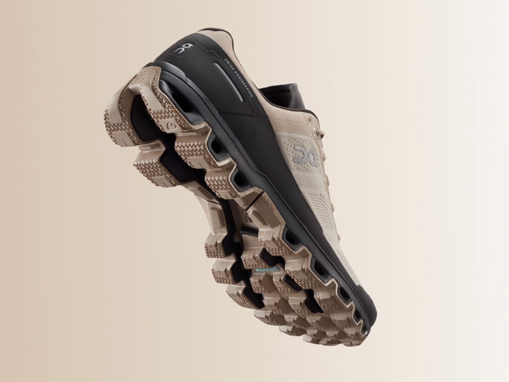 Hiking Cloudventure shoe with textured sole on a beige background
