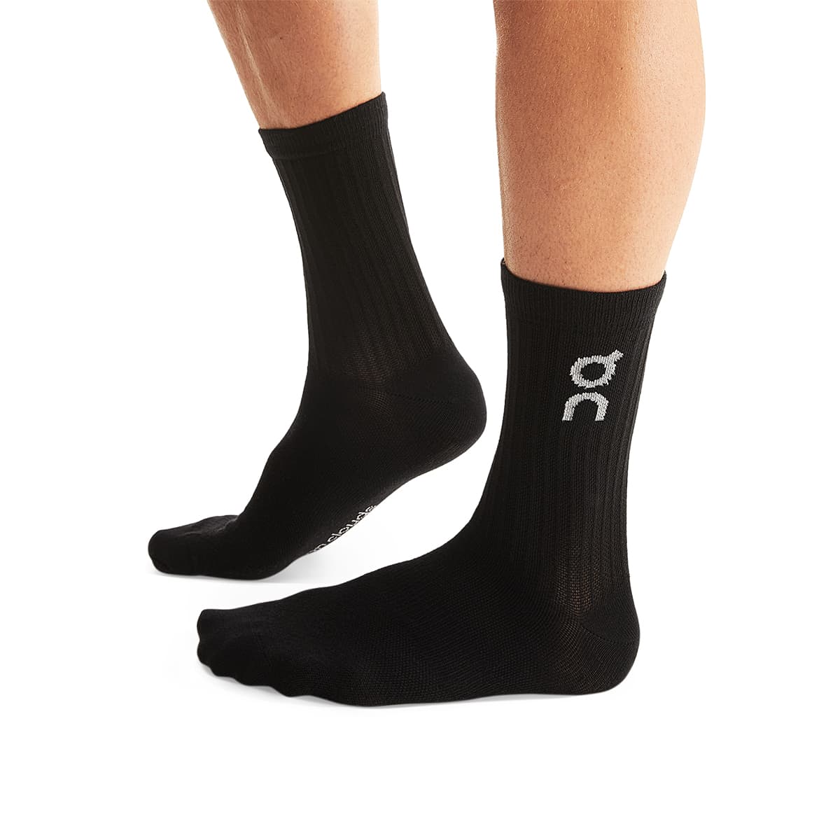 Man wearing the On Logo Sock 3 Pack Colour Black - Side Angle