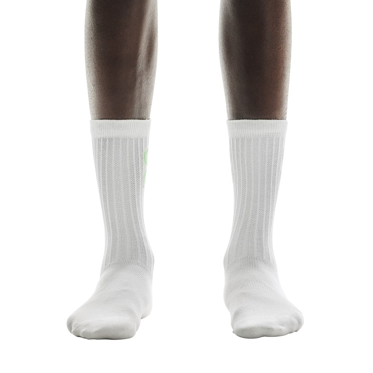 Front view of model wearing the white pair from the On Logo Sock 3-Pack in Desert Wash