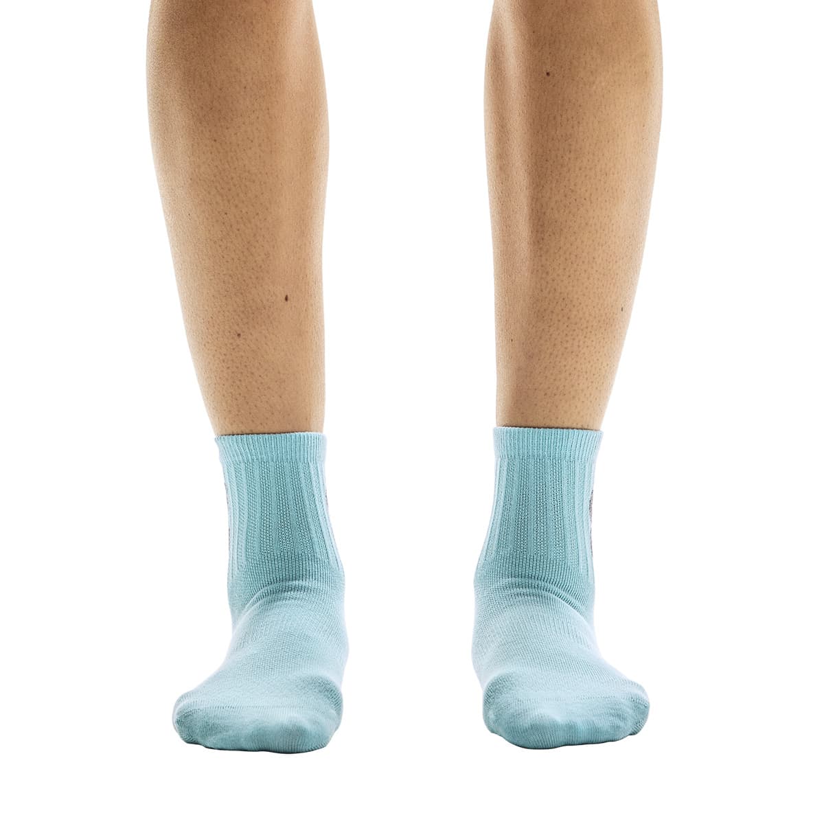 Front view of model wearing the blue pair from the On Logo Sock Mid 3-Pack in Desert Wash