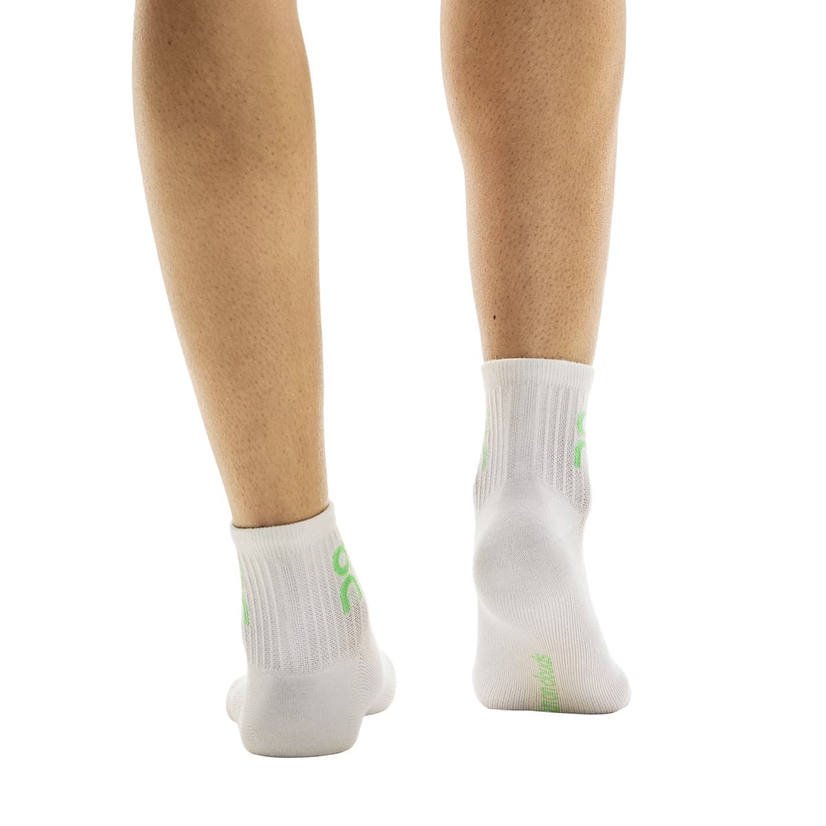 Rear view of model wearing the white pair from the On Logo Sock Mid 3-Pack in Desert Wash