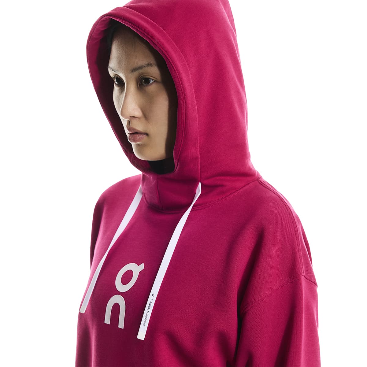 Female model wearing the On Apparel - Club Hoodie Colour Grenadine with hood up