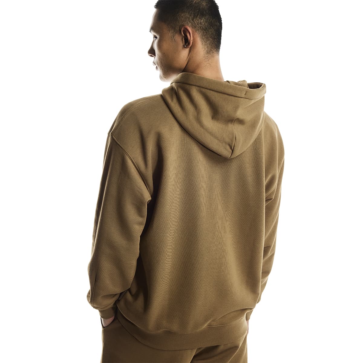 Male model wearing the On Apparel - Club Hoodie Colour Nutmeg, looking over shoulder