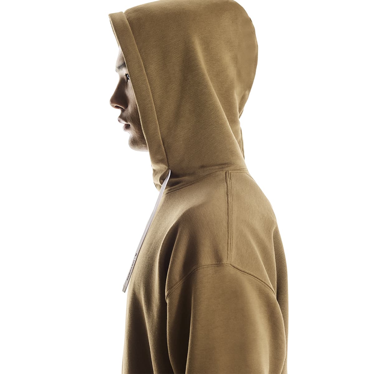 Side profile of male model wearing the On Club Hoodie in Nutmeg with hood up