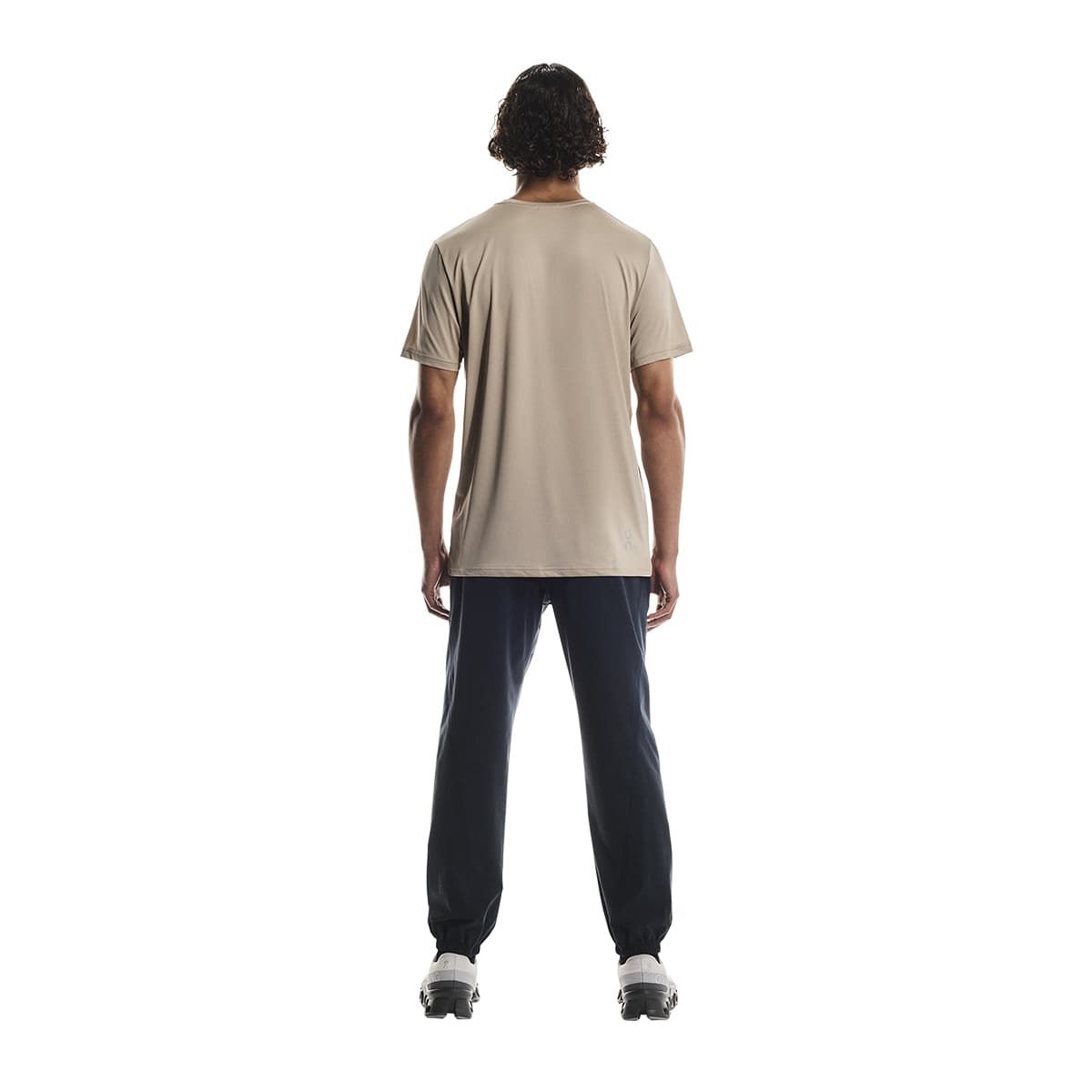 Rear view of male model wearing the On Apparel - Core T Colour Desert