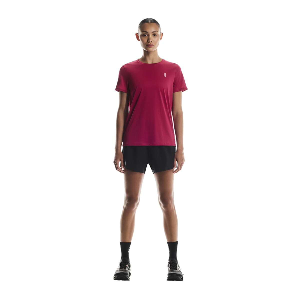 Woman wearing the On Apparel - Core T Colour Grenadine, standing full-body front view #color_grenadine