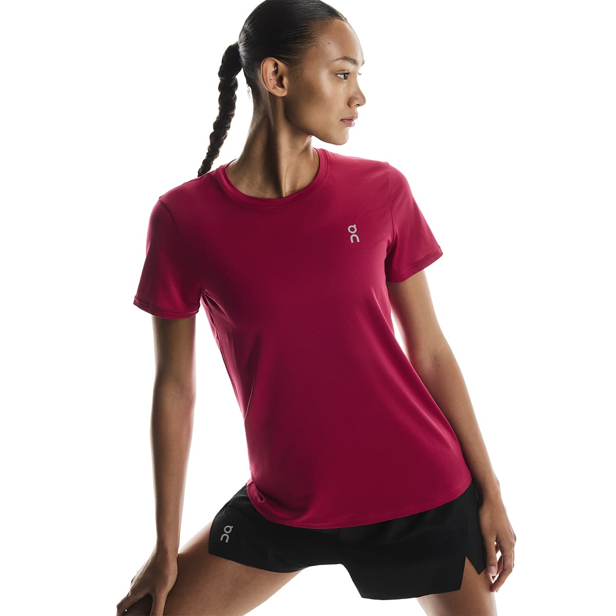Woman wearing the On Apparel - Core T Colour Grenadine in a side stretch pose