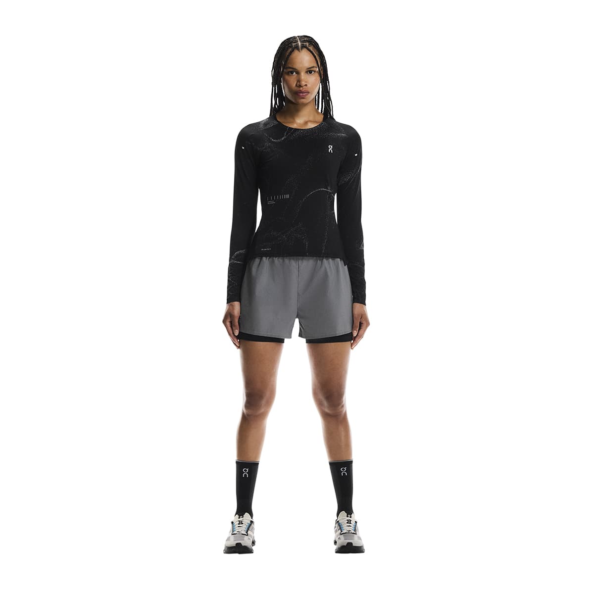 Full-body of female model wearing the On Apparel - Performance Long T Lumos Colour Black