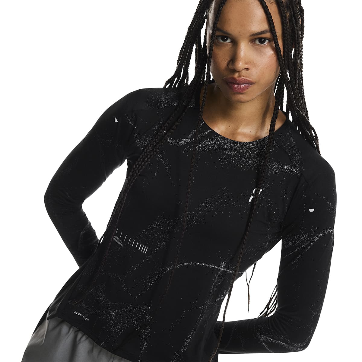 Female model wearing the On Apparel - Performance Long T Lumos Colour Black, back detail view