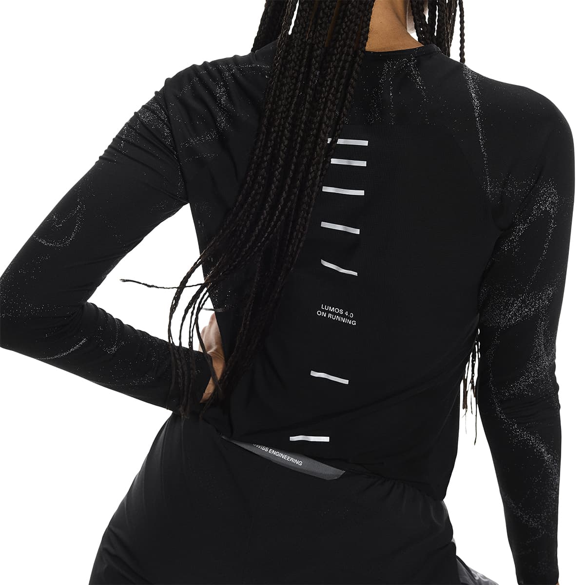 Rear view of female model wearing the On Apparel - Performance Long T Lumos Colour Black