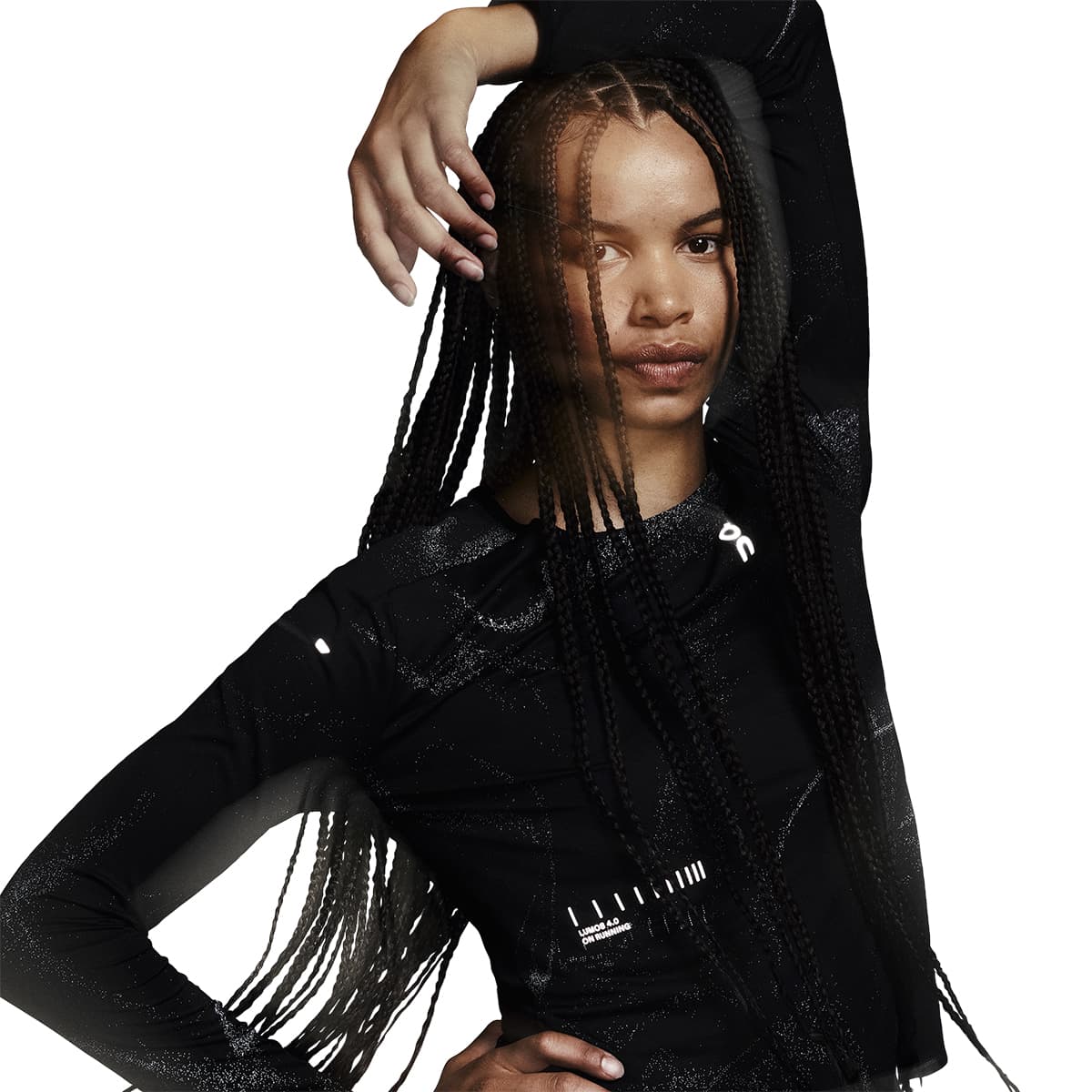 Female model wearing the On Apparel - Performance Long T Lumos Colour Black in a stylized pose