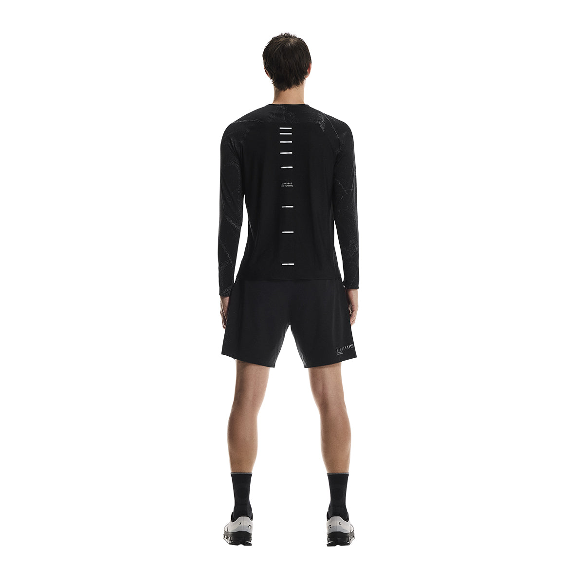 Full back view of male model wearing the On Performance Shorts Lumos in Black