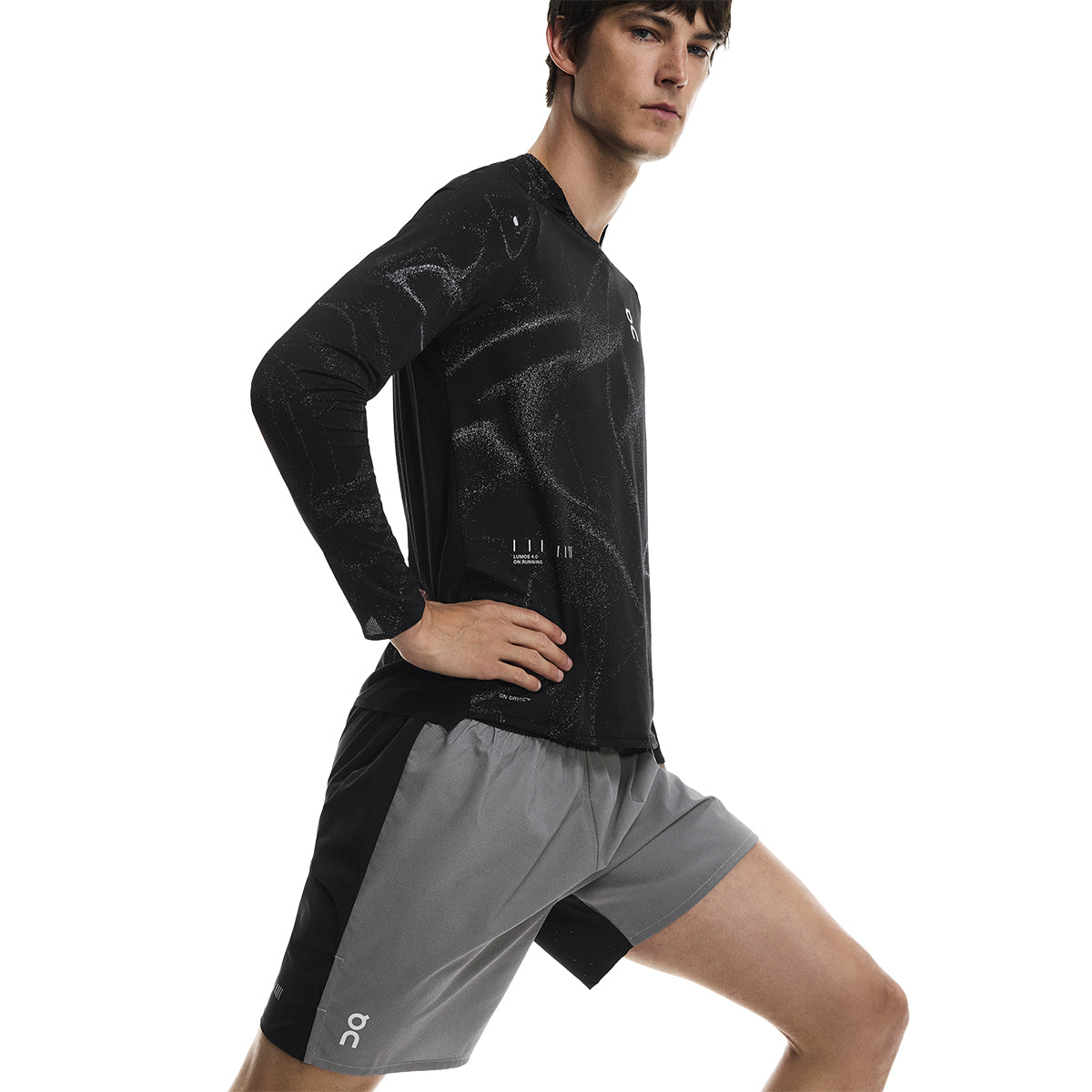 Side view of male model stretching in the On Performance Shorts Lumos in Black