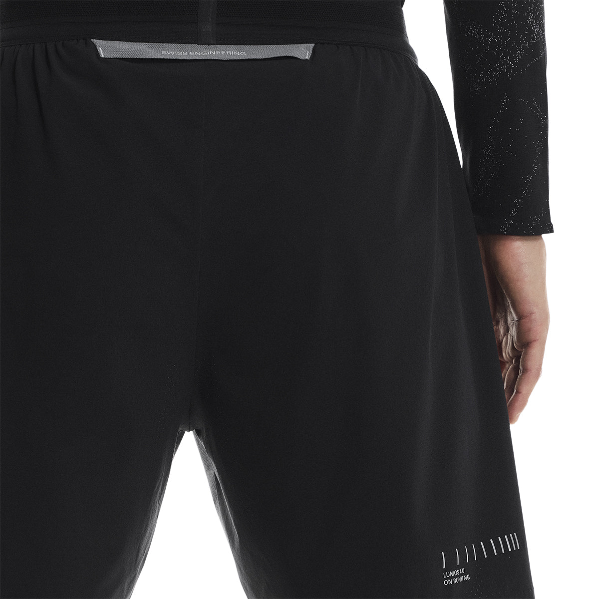 Close-up back view of the On Performance Shorts Lumos in Black showing reflective strip