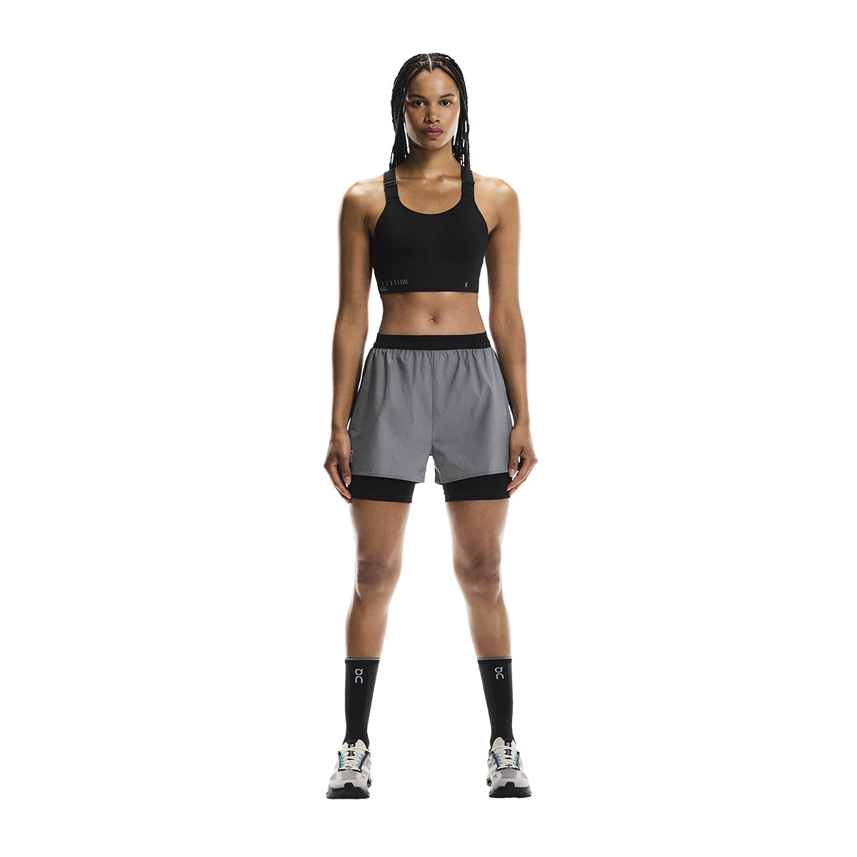Full front view of female model wearing the On Performance Shorts Lumos in Black