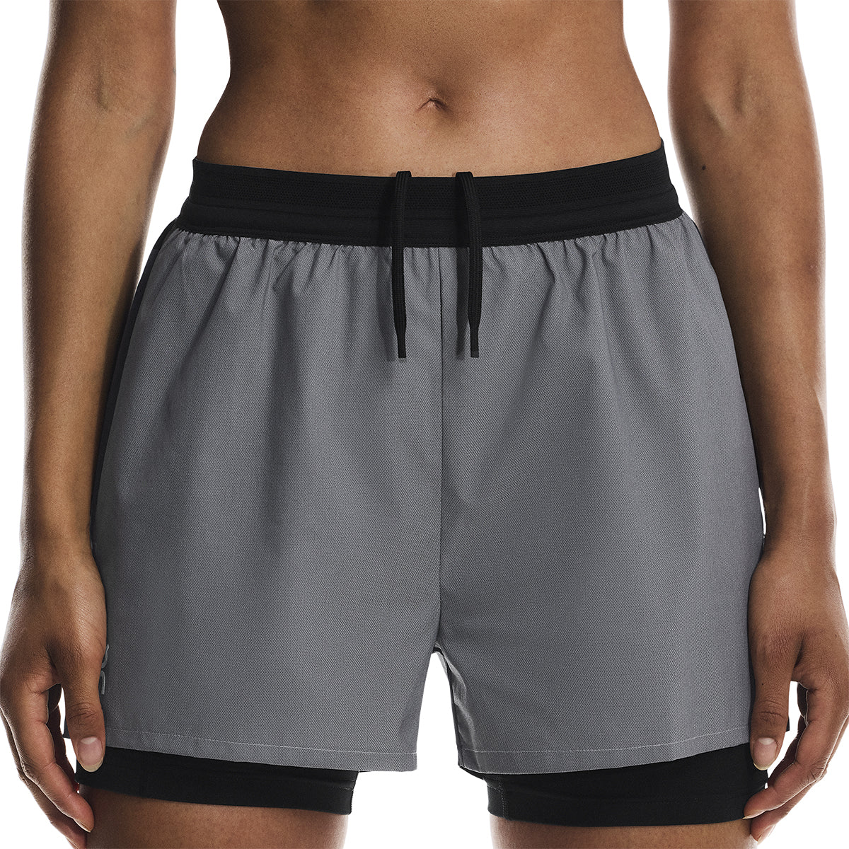 Close-up front view of the On Performance Shorts Lumos in Black showing waistband and drawstring