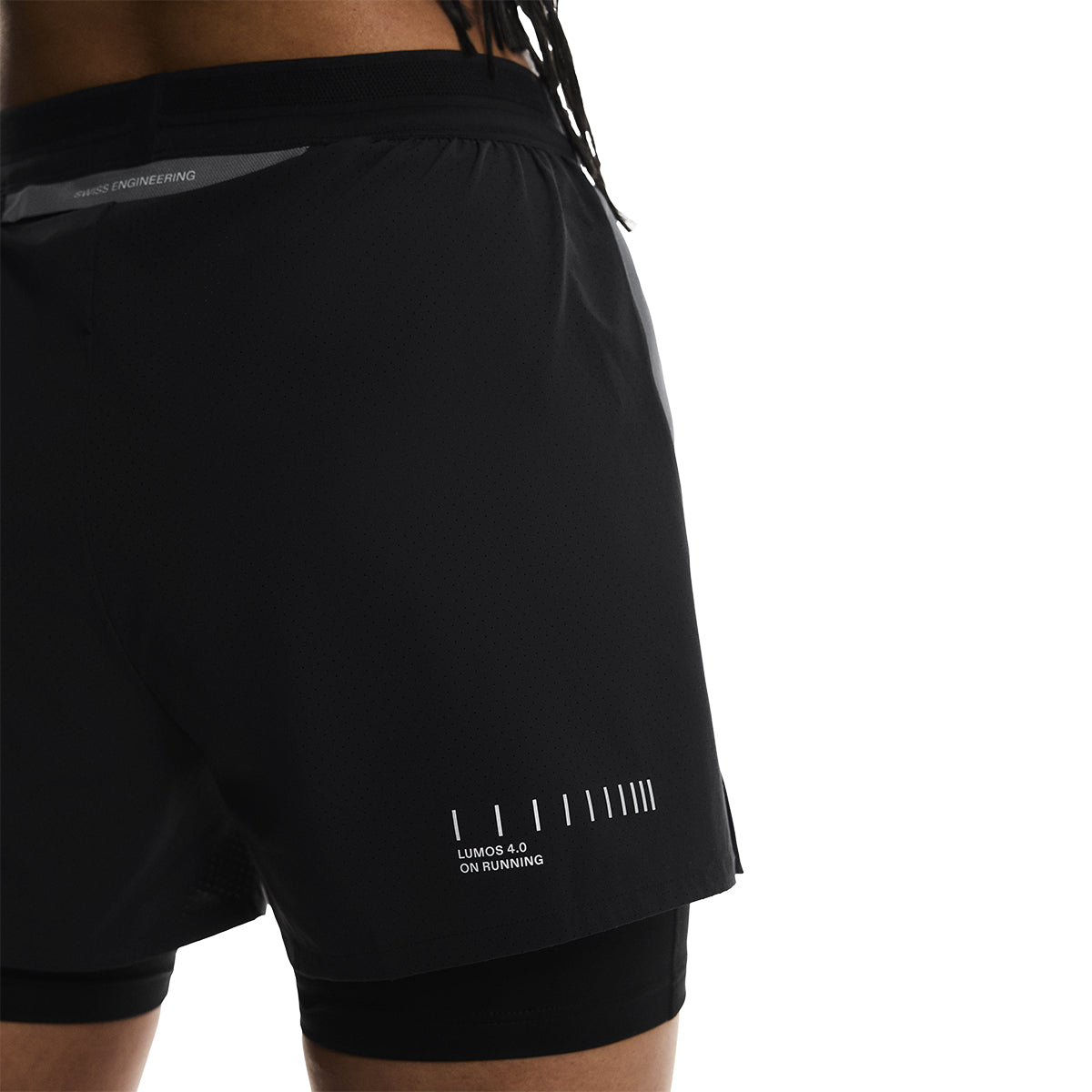Close-up back detail of the On Performance Shorts Lumos in Black showing Lumos 4.0 reflective print