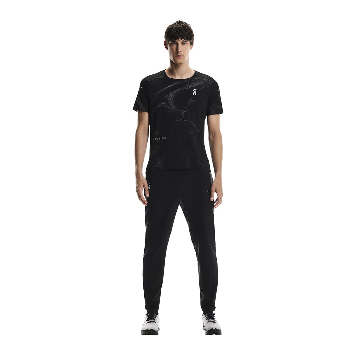 Full-body of male model wearing the On Apparel - Performance T Lumos Colour Black