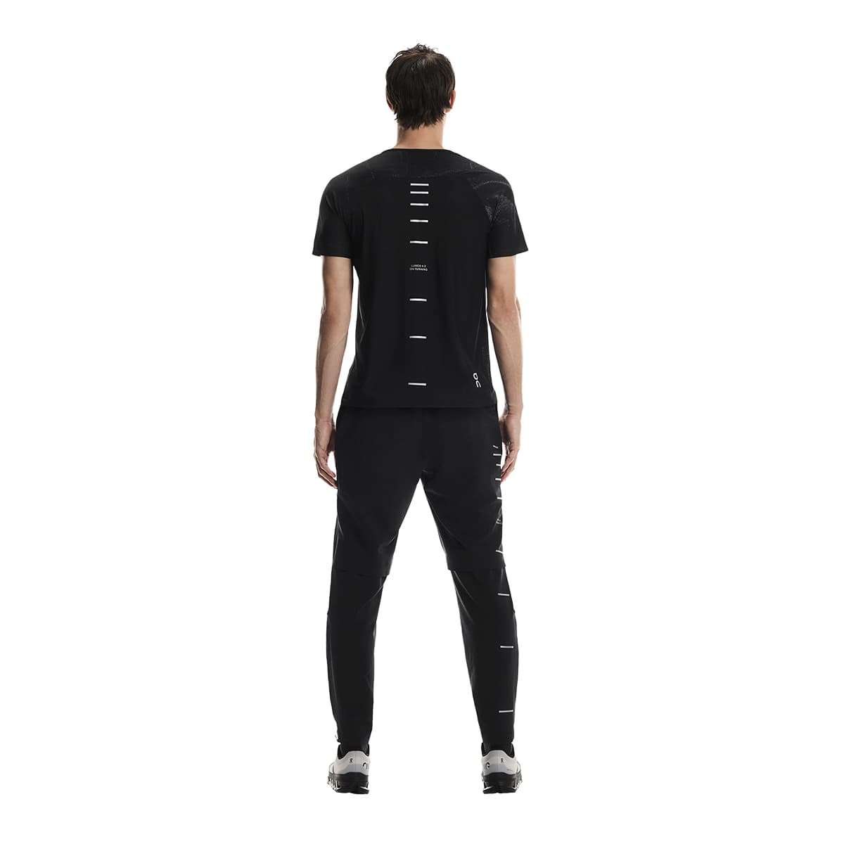 Rear view of male model wearing the On Apparel - Performance T Lumos Colour Black