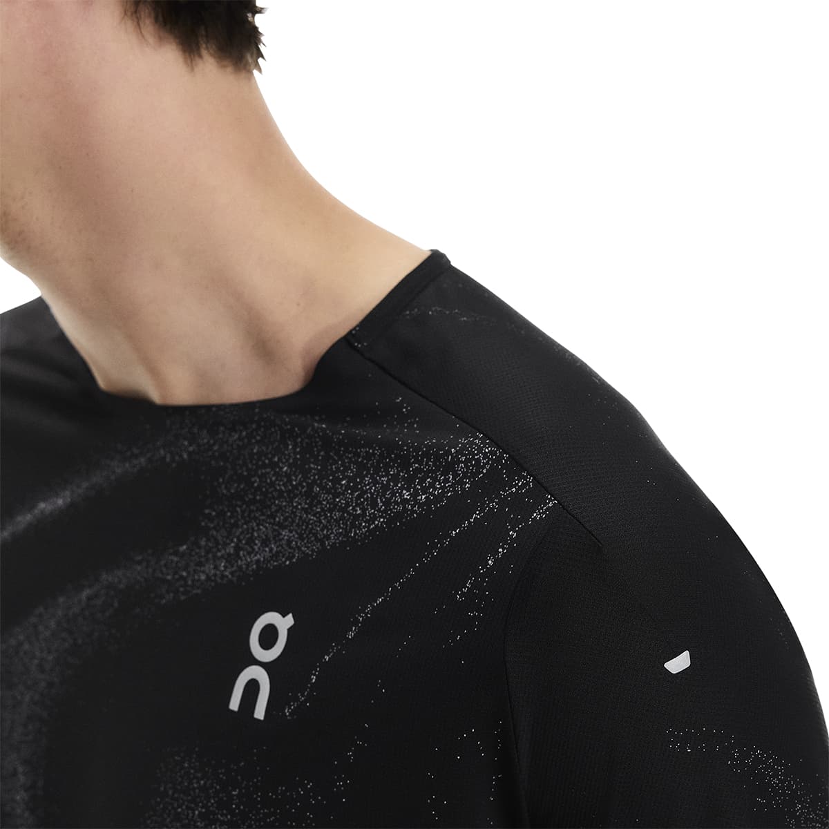 Close-up of male model wearing the On Apparel - Performance T Lumos Colour Black, showing shoulder detail