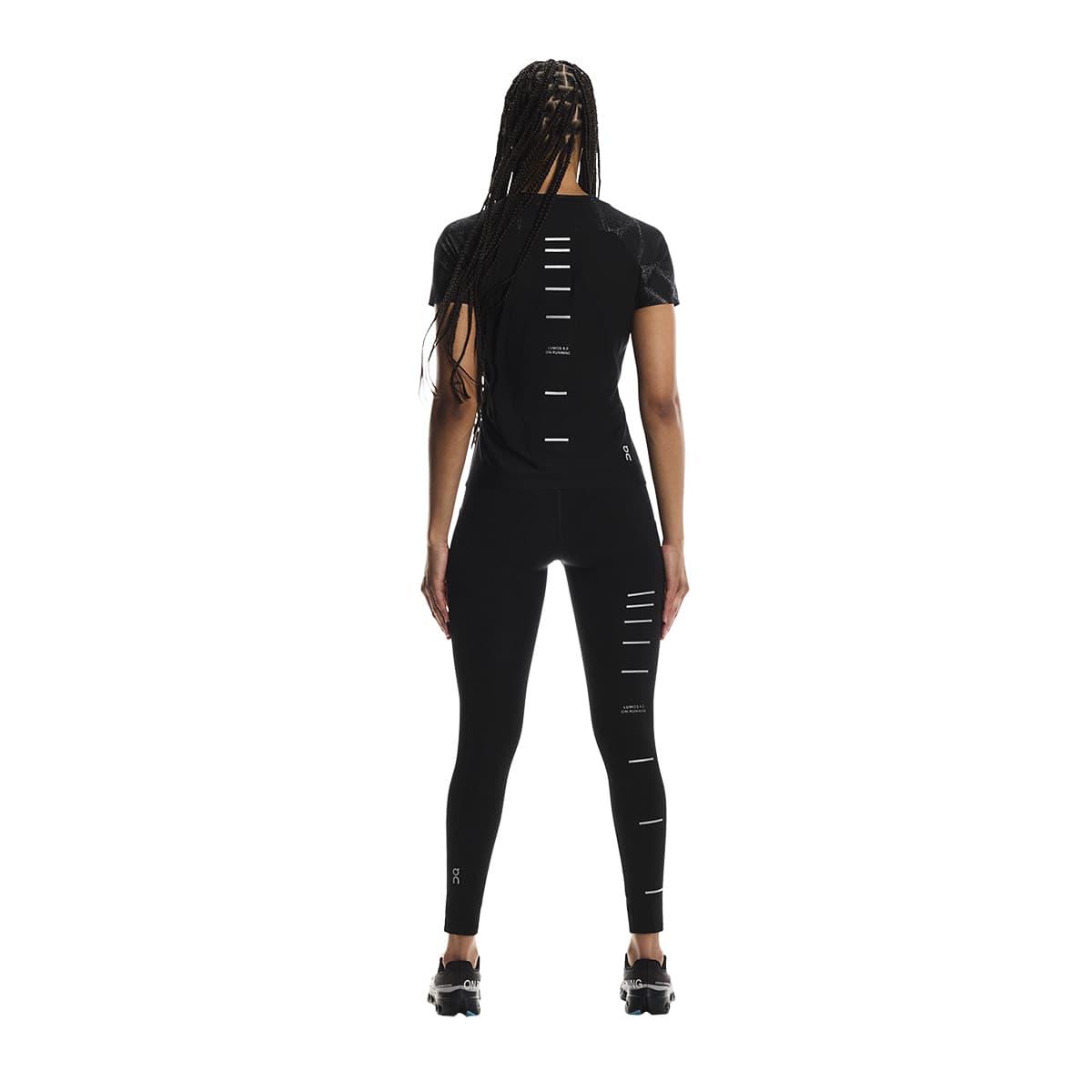 Rear view of female model wearing the On Apparel - Performance T Lumos Colour Black