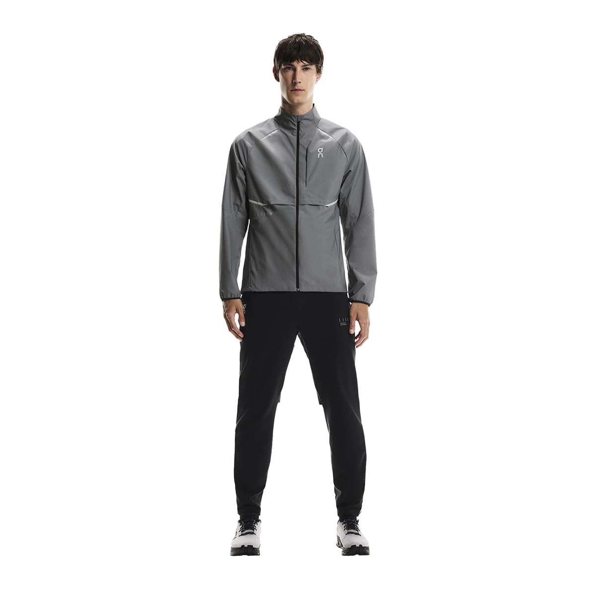Full body shot of male model wearing the On Weather Jacket Lumos Colour Eclipse