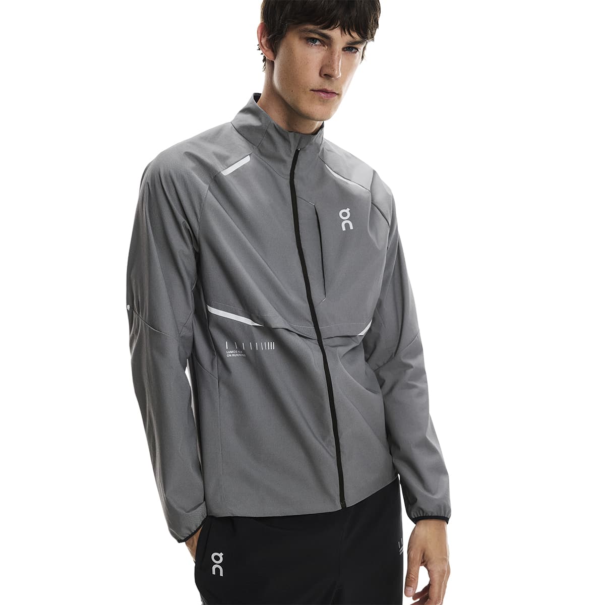 Close up view of a male model wearing the On Weather Jacket Lumos Colour Eclipse
