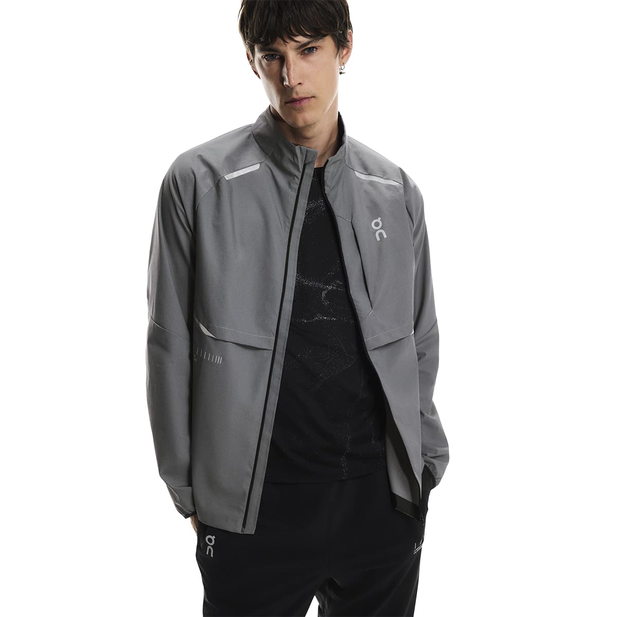 Front view of a male model wearing the On Weather Jacket Lumos Colour Eclipse