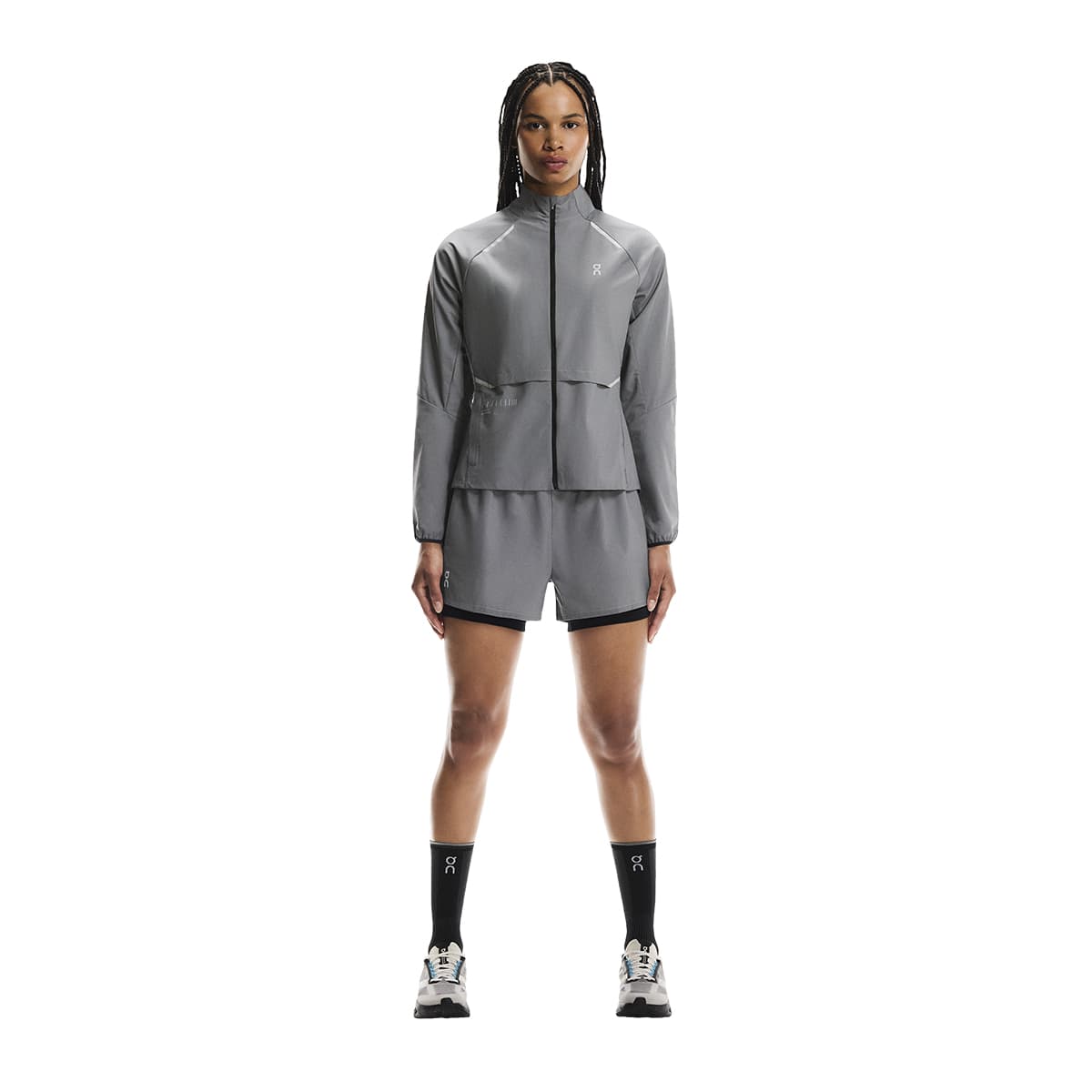 Full body shot of female model wearing the On Weather Jacket Lumos Colour Eclipse