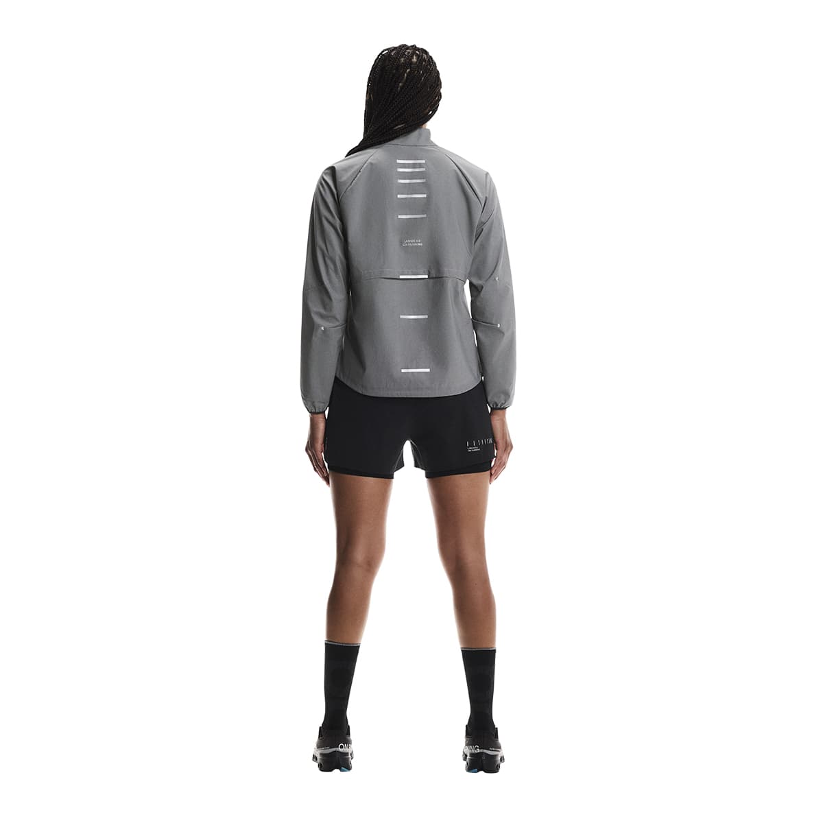 Rear Full body shot of female model wearing the On Weather Jacket Lumos Colour Eclipse