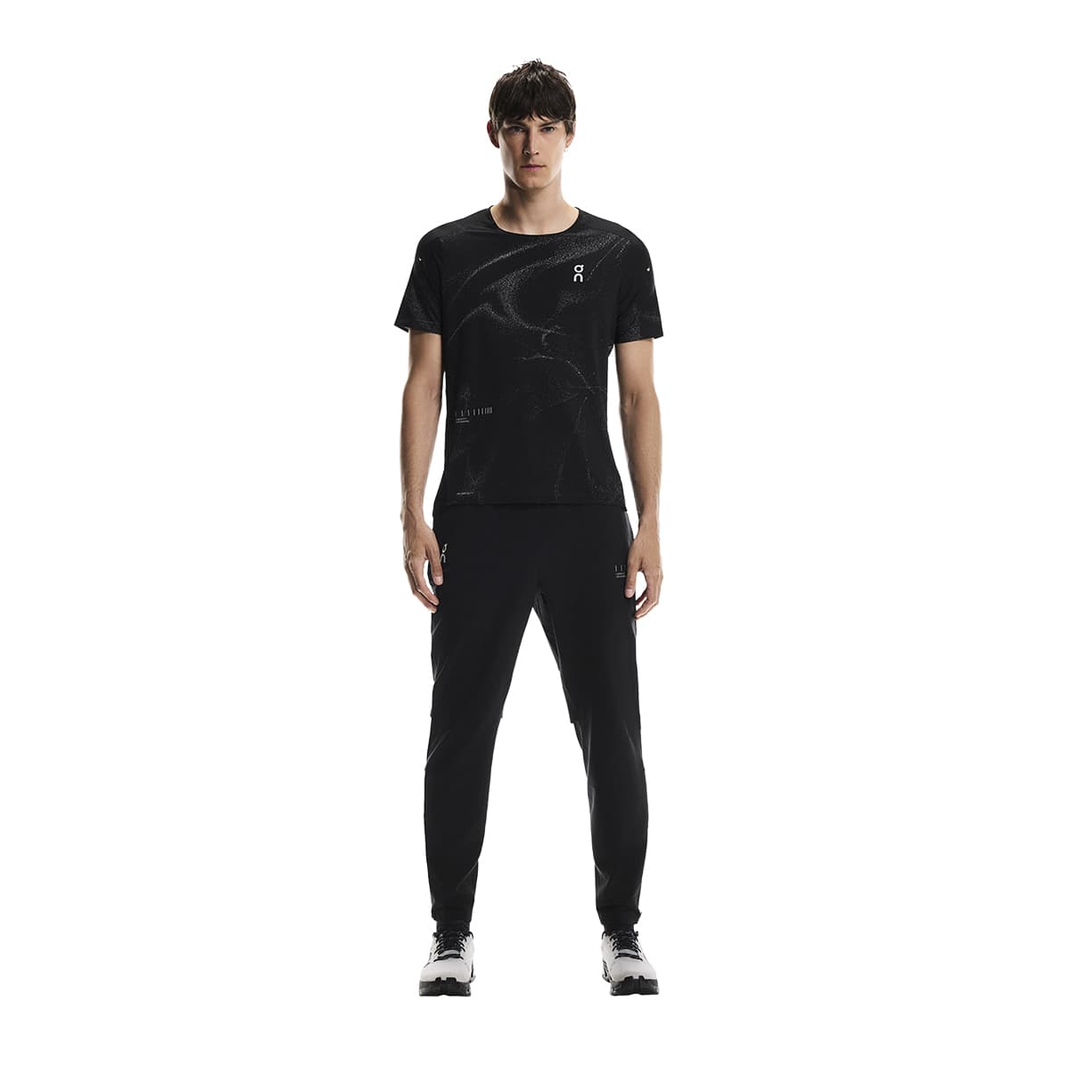 Full front view of male model wearing the On Weather Pants Lumos in Black paired with matching top