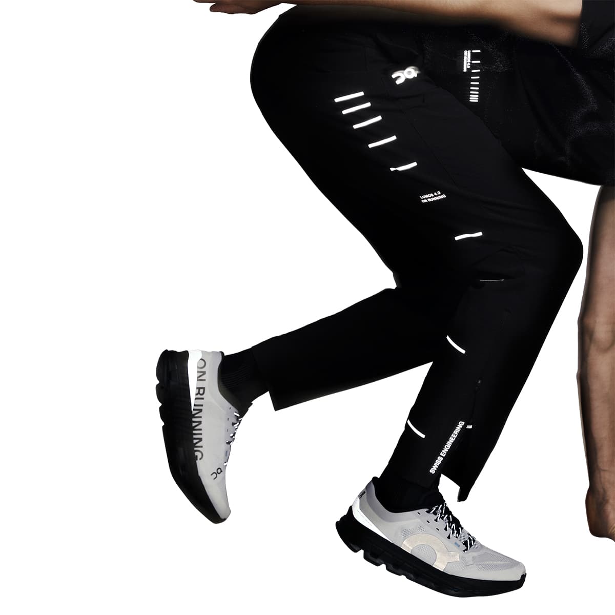 Motion shot showing full reflective detail on the On Weather Pants Lumos in Black during movement