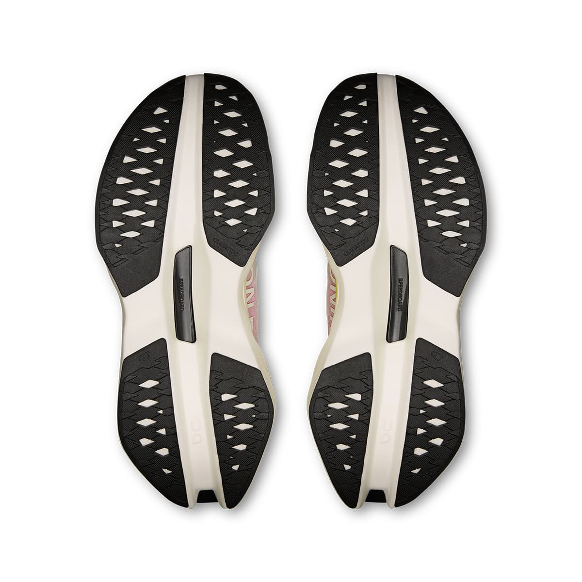 Soles of the On Cloudboom Max Lime-Raspberry women’s running shoes