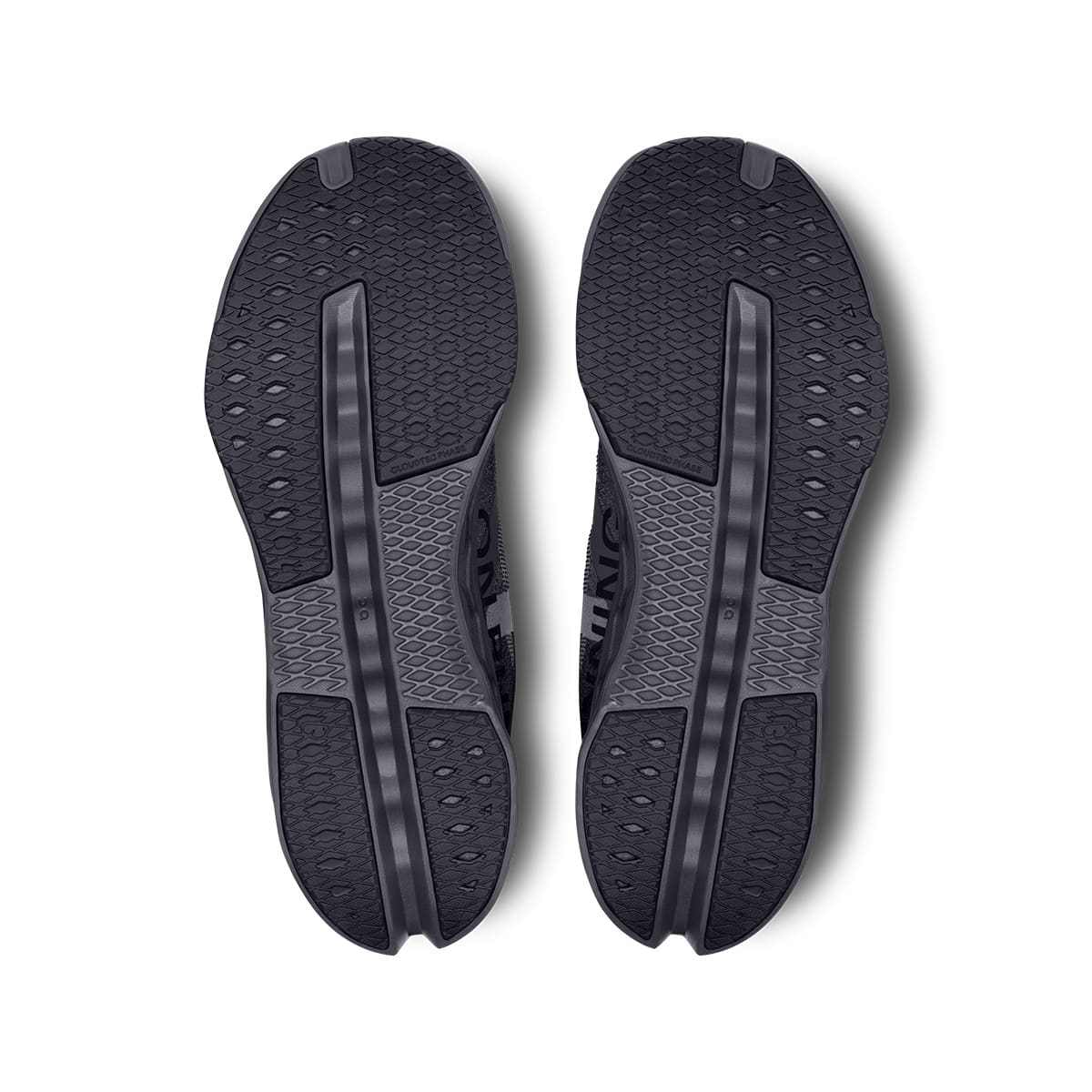 Soles of the On Cloudsurfer Next Black Eclipse men’s running shoes