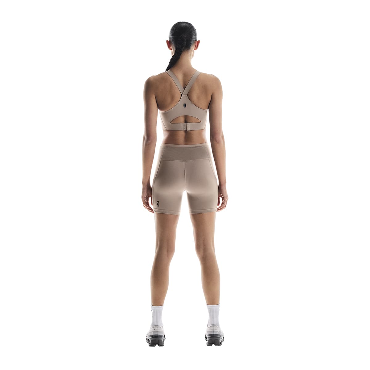 Woman wearing the On Performance Short Tights Colour Cinder - Back View