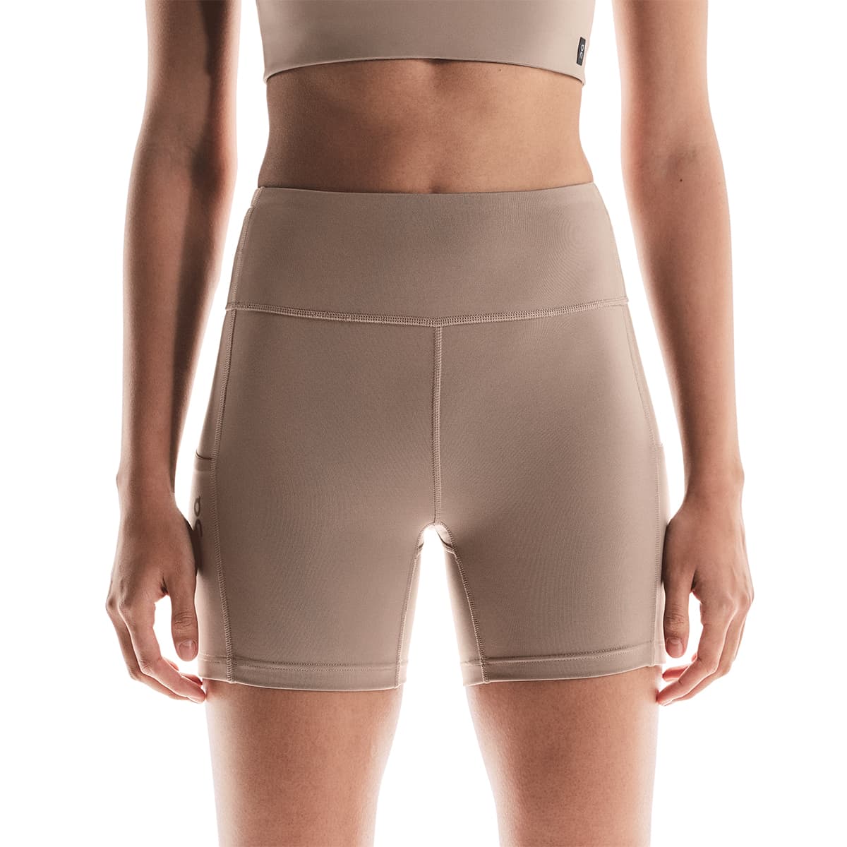 Woman wearing the On Performance Short Tights Colour Cinder - Front View Zoom