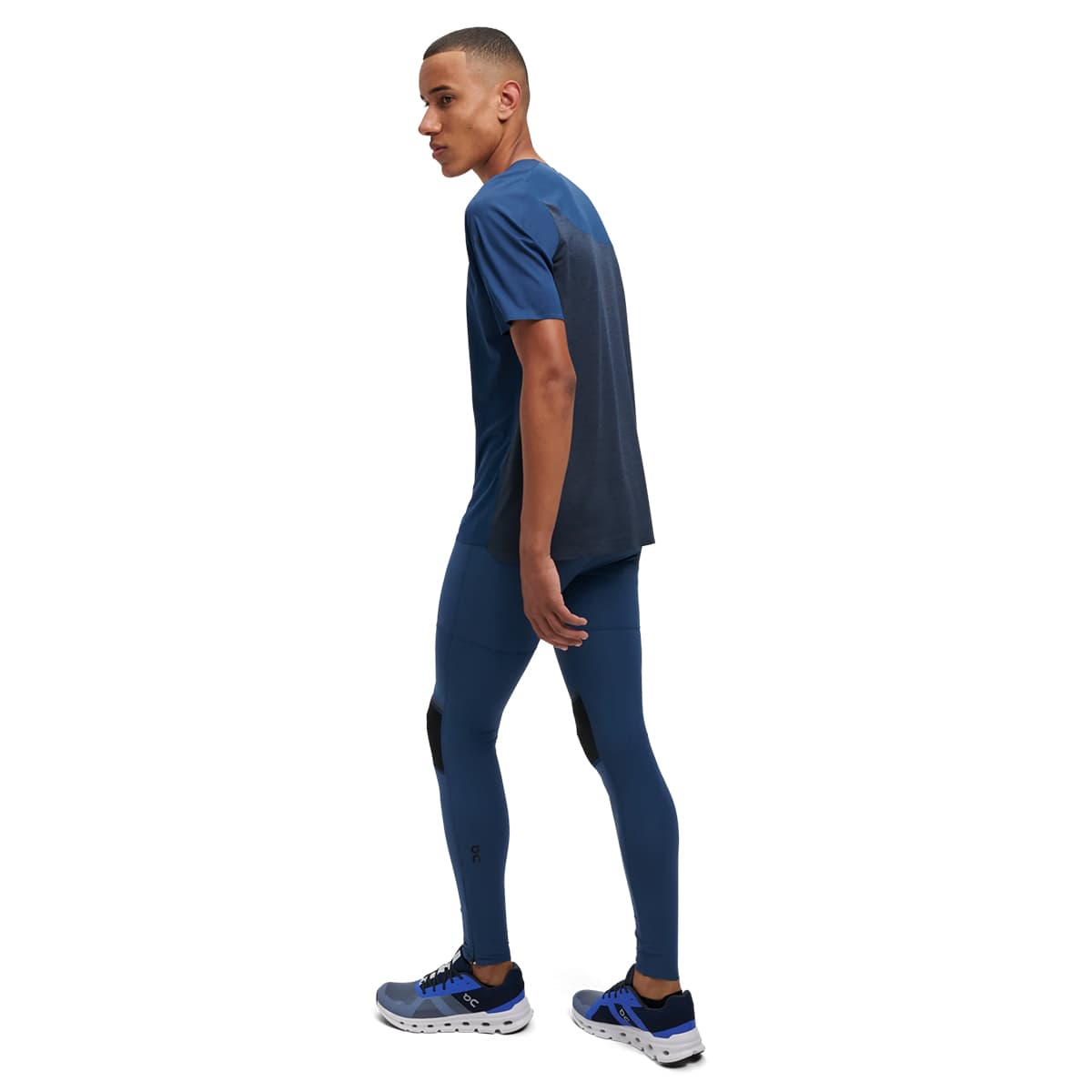 Man wearing the On Performance T Colour Denim-Navy - Back View Side Angle