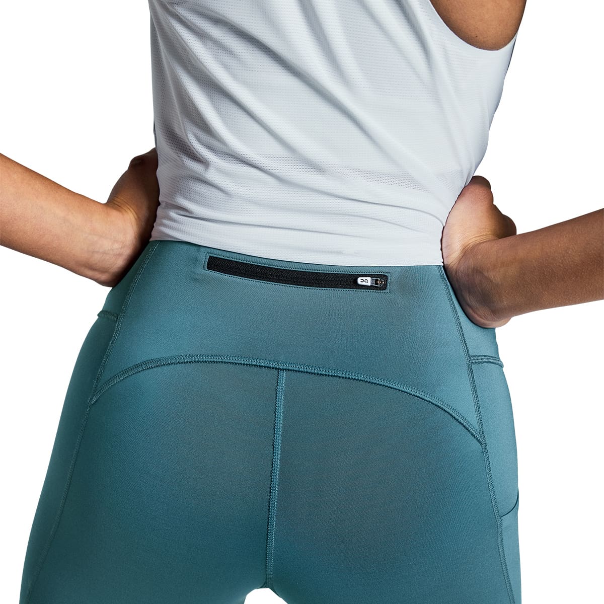 Woman wearing the On Performance Tights 7-8 Colour Storm - Back Secure Zip
