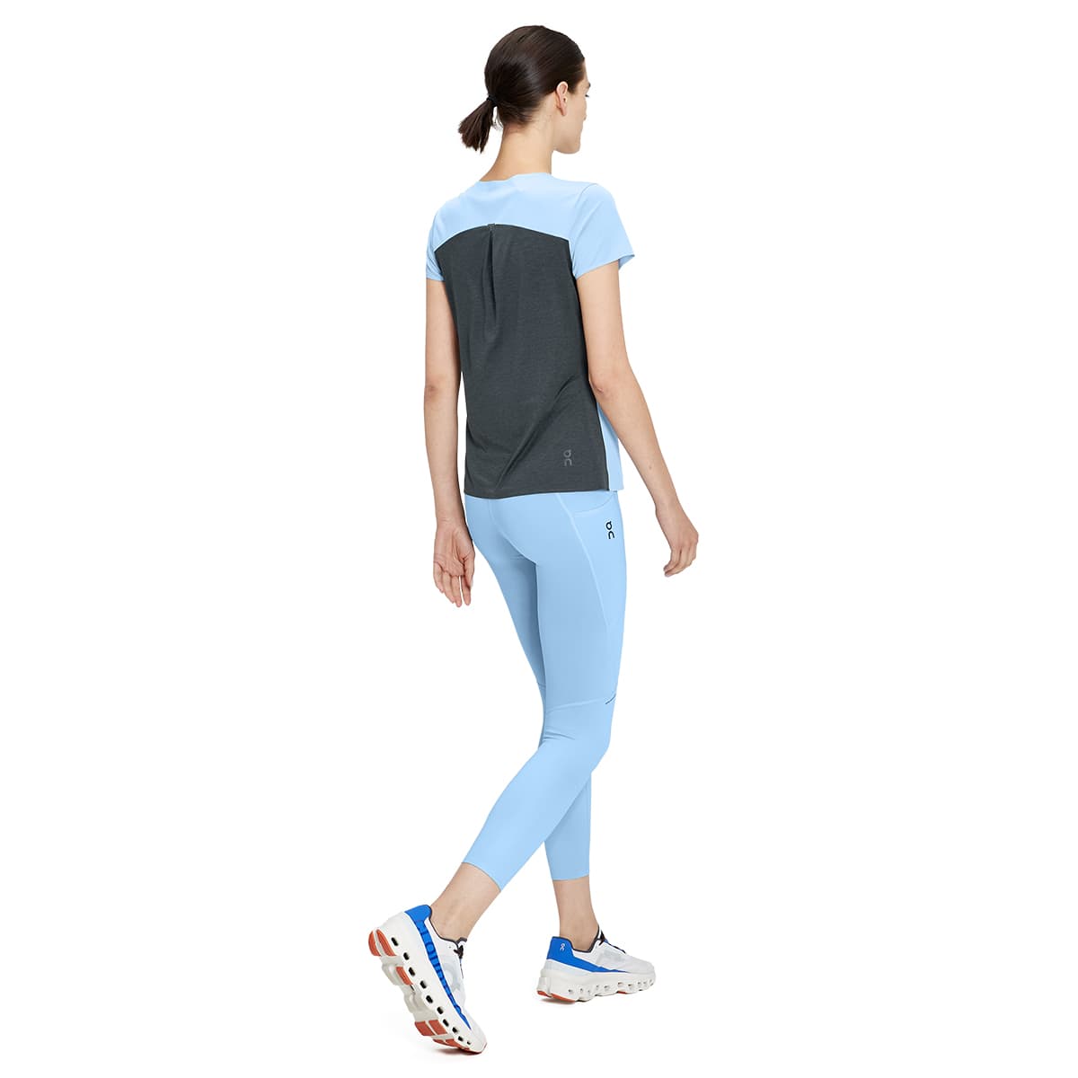 Woman wearing the On Performance Tights 7-8 Colour Stratosphere - Back Motion