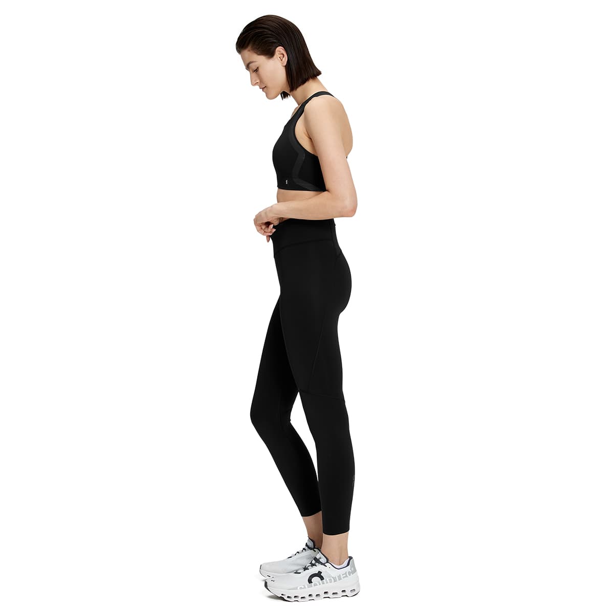 Woman wearing the On Performance Tights 7-8 Colour black - Side Profile