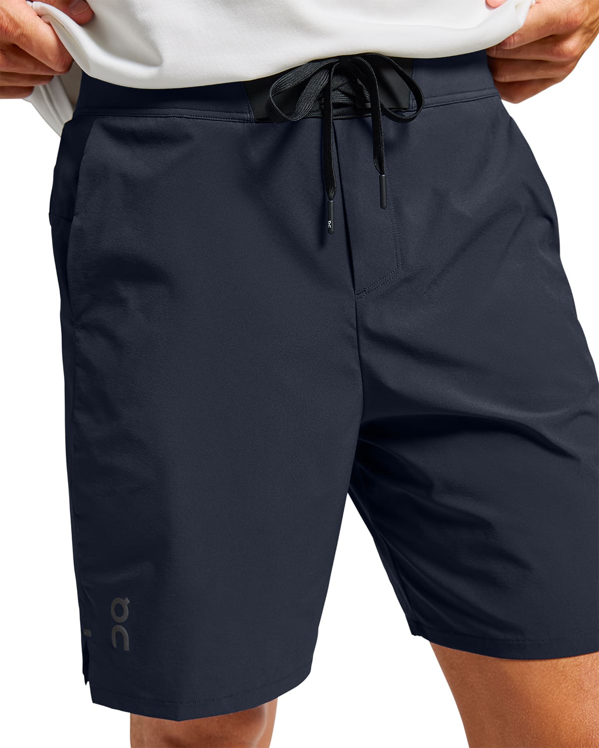 Man wearing the On Preformance Hybrid Shorts Colour Navy - Detail Front Draw Strings