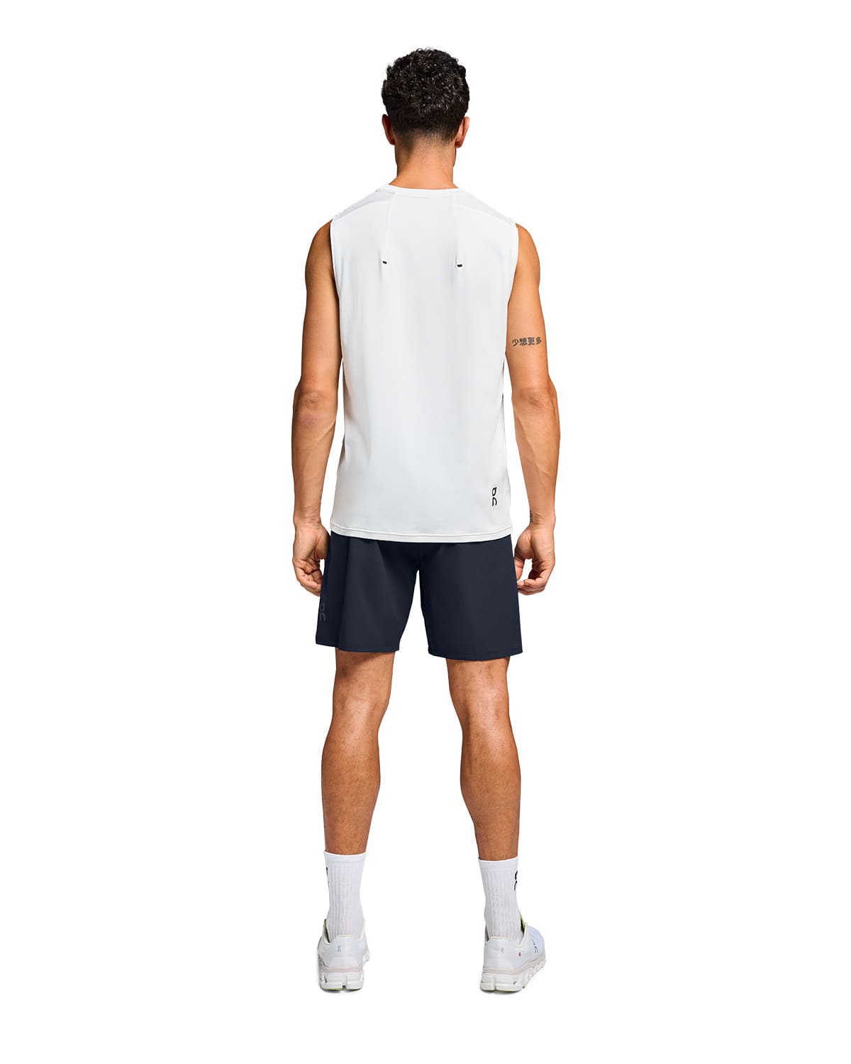 Man wearing the On Preformance Hybrid Shorts Colour Navy - Back View