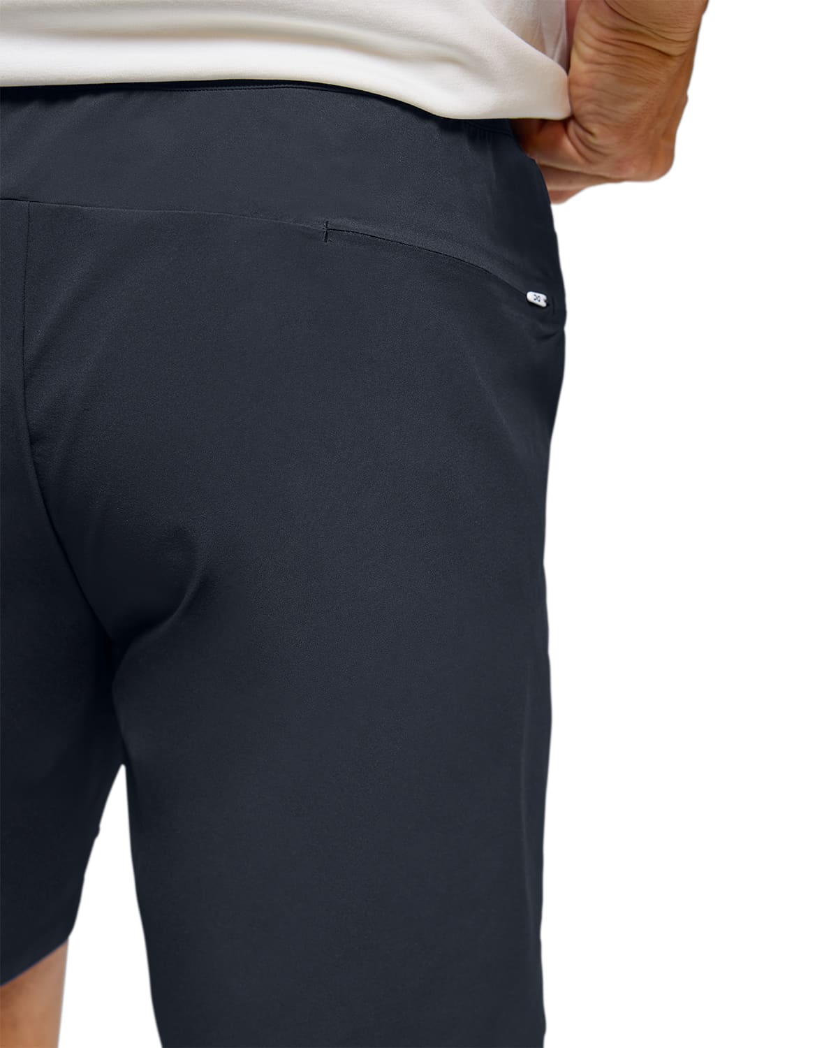 Man wearing the On Preformance Hybrid Shorts Colour Navy - Detail Back Zip Pocket