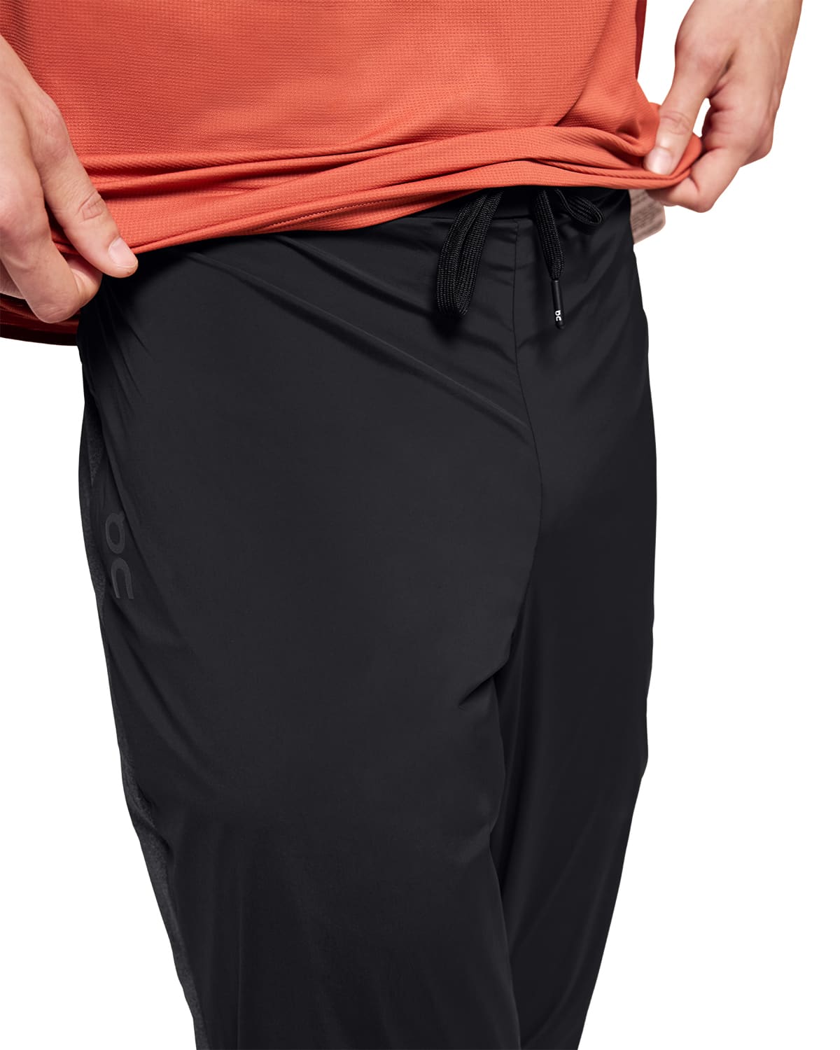 Man wearing the On Weather Pants Colour Black - Front View Draw String