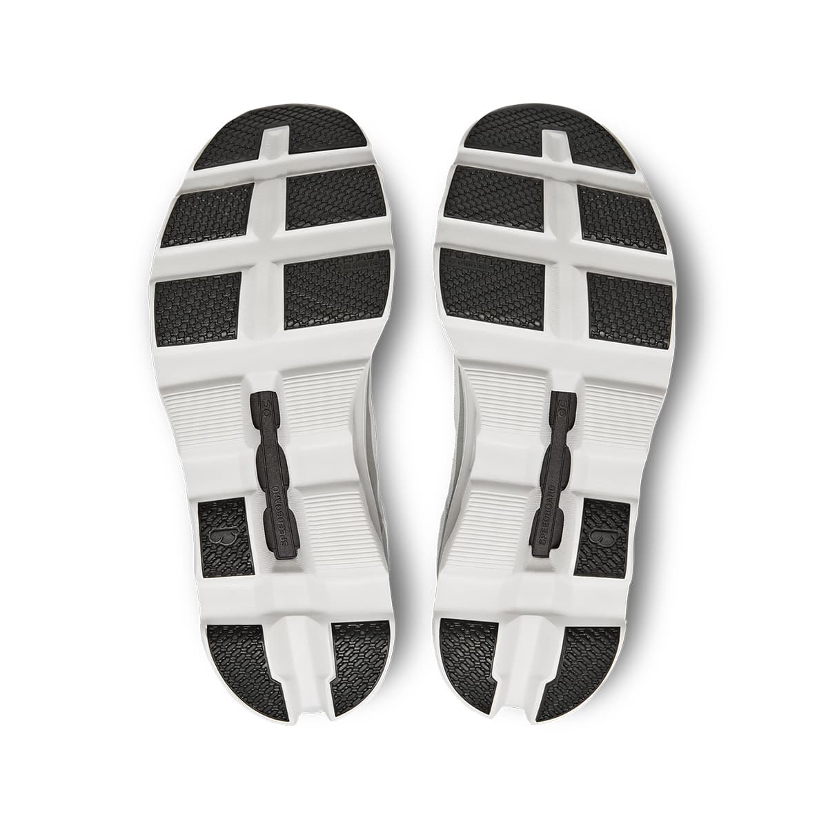 Soles of the On Cloudmonster All White women’s running shoes