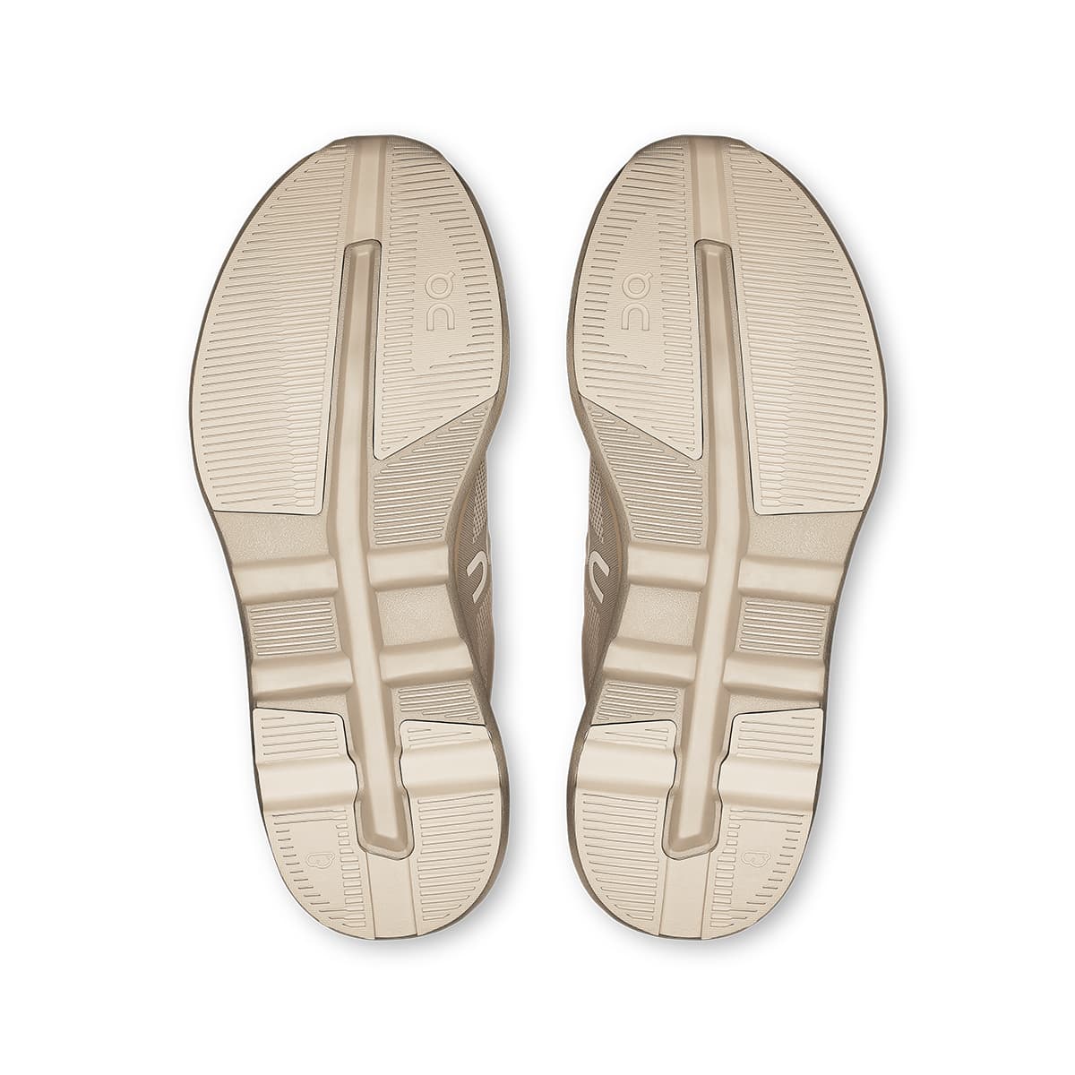Soles of the On Cloudzone Pearl-Truffle women’s running shoes