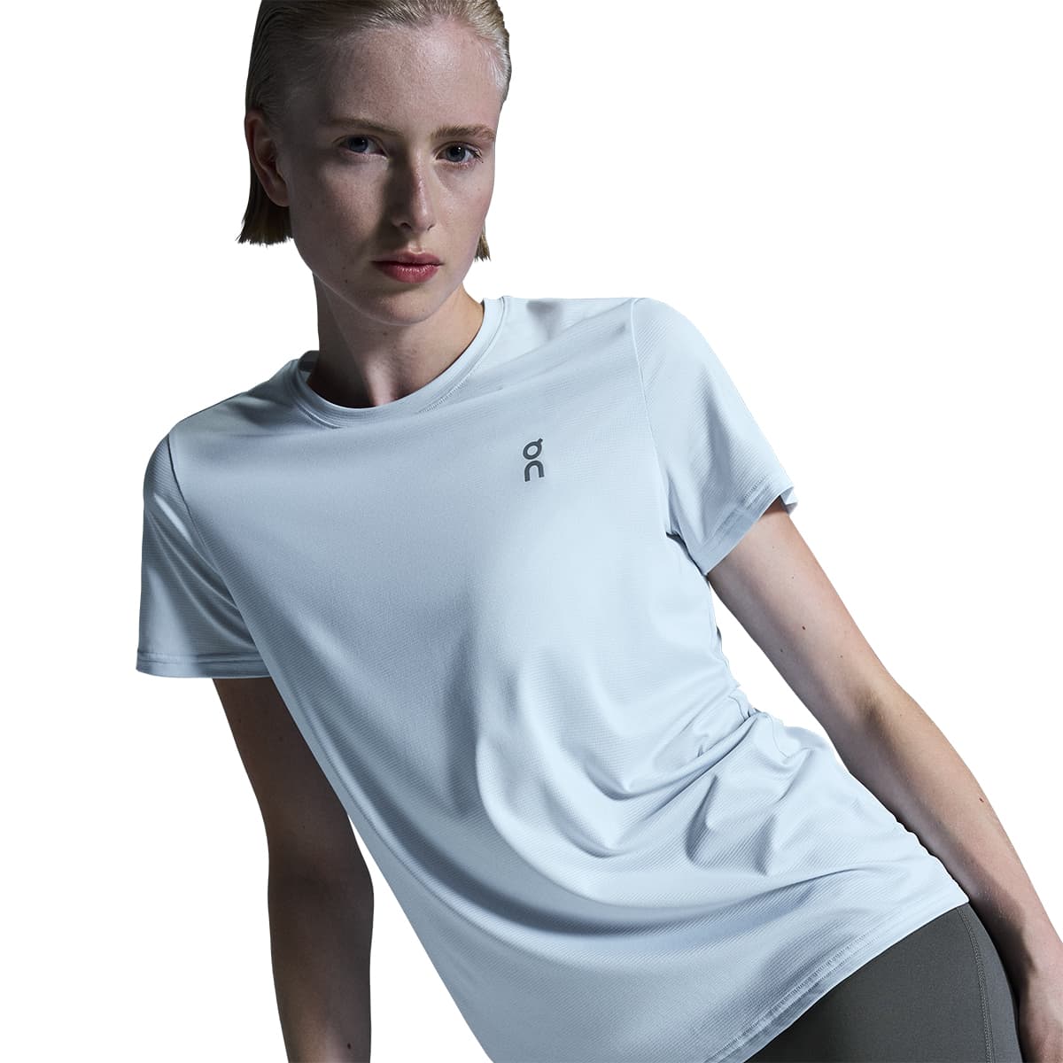 Woman wearing the On Core T Colour Arctic - Front View Motion