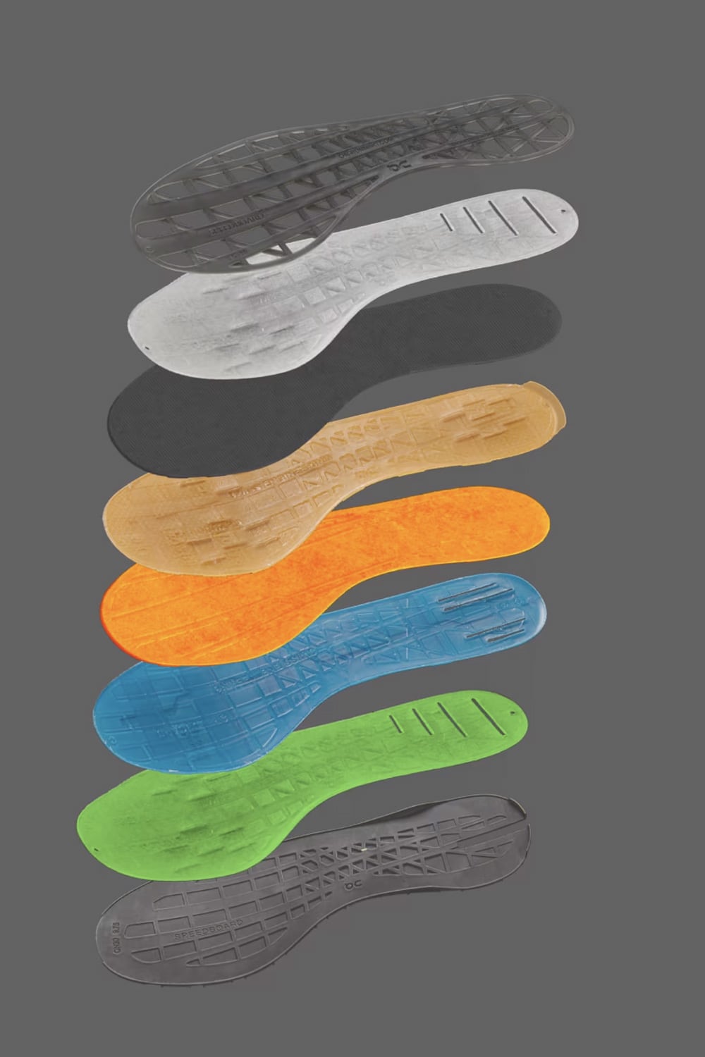 Set of colorful shoe insoles on a gray background - Speedboard Technology